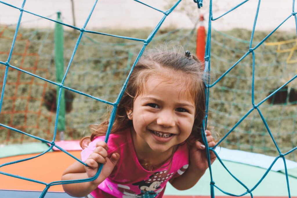 girl smiling while playing outside