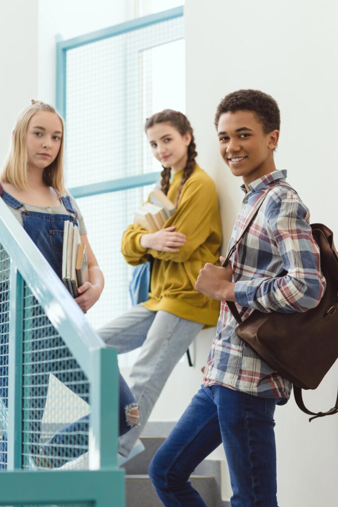 3 teenagers standing on steps